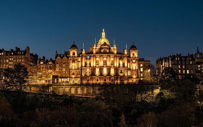 Landscape of a lit up building with warm lighting at night